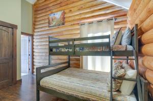 a bedroom with two bunk beds in a log cabin at The Cliffrose Cabin - Hike, Relax, Explore! in Kanab