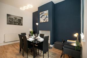 a dining room with a black table and black chairs at LARGE CITY CENTRE PROPERTY in Derby