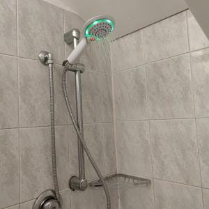 a shower with a shower head in a bathroom at Loft Mansardato in Monza +45 photos