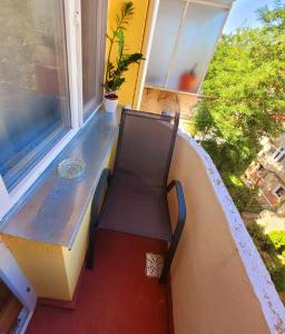 a bench sitting on a balcony with a window at Casa Rusu - Govandari -Self check in-24h in Reşiţa