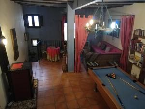 a living room with a pool table and a couch at La Vieja Escuela in Fuentes de Rubielos