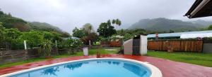 una grande piscina in un cortile con recinzione di Heipoe Lodge a aUturoa