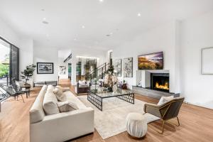a living room with a couch and a fireplace at Beverly Hillside Haven in Los Angeles