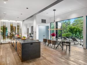 a kitchen and dining room with a table and chairs at Beverly Hillside Haven in Los Angeles