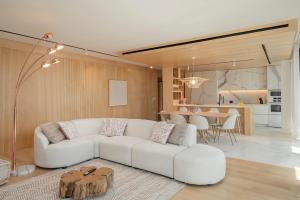 a living room with a white couch and a table at Savoy Insular I by An Island Apart in Funchal