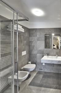 a bathroom with a sink, toilet and bathtub at Dedo Boutique Hotel in Florence