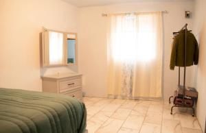 a bedroom with a bed and a dresser and a window at Guanajuato Centro wifi gratis totalmente privado in Guanajuato