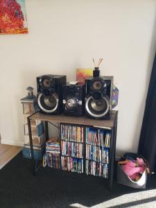 a book shelf with two speakers and dvds at Paihia Retreat in Paihia