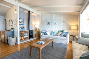 a living room with a couch and a table at Clifftop Sanctuary in Oneroa