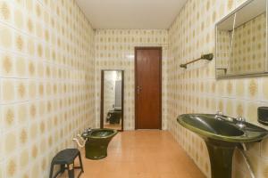 a bathroom with a sink and a toilet at Rental Florianópolis - Acomodações Residenciais in Florianópolis