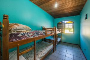 a bedroom with two bunk beds and a window at Rental Florianópolis - Acomodações Residenciais in Florianópolis