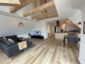 a living room with a couch and a table at aday - Frederikshavn Penthouse in Frederikshavn