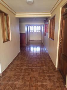 an empty hallway of a home with a flooring at Hotel el LUCERO in Oruro
