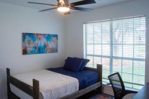 a bedroom with a bed with a ceiling fan and a window at Updated Oklahoma City Home about 11 Mi to Bricktown! in Oklahoma City +29 photos
