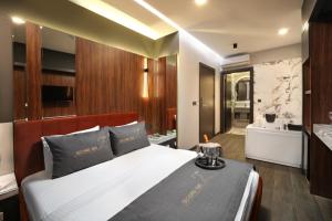 a bedroom with a large bed and a bathroom at Second Suit Hotel in Istanbul