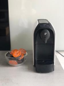 a black phone sitting next to a bowl of oranges at city apartment nice & comfy in Krefeld