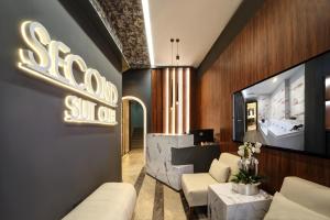 a lobby with a sofa and a sign on the wall at Second Suit Hotel in Istanbul