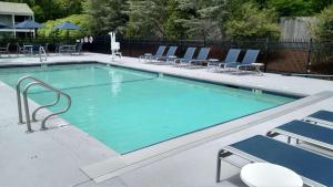 a large swimming pool with chairs at Best Western Plus Cold Spring in Plymouth