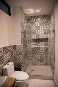 a bathroom with a toilet and a shower at HOTEL BOUTIQUE MONARCA in El Paraíso