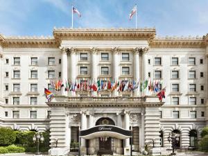 a large white building with flags on top of it at Fairmont San Francisco in San Francisco