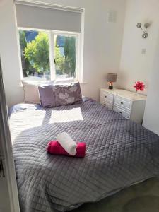 a bedroom with a bed with two towels on it at Three-Bedroom Home in Tulfarris Village, Wicklow in Blessington