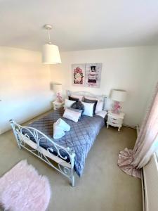 a bedroom with a bed with a blue comforter at The Farm Rooms in Stapleford Tawney