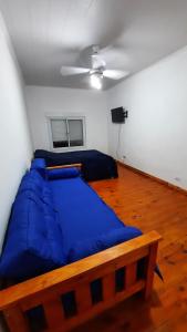 a large blue bed in a room with a ceiling at Caribe in Concepción del Uruguay