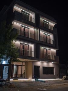 a black building with lights on it at night at HOTEL HIBA in Nouakchott