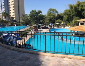 a group of three pools with people in them at Golden Dolphin Express in Caldas Novas