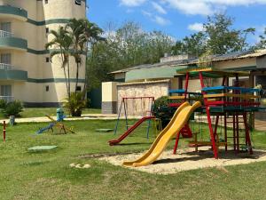 a playground with a slide and a slideintend at Flat B306 Village Aldeia das Águas in Barra do Piraí