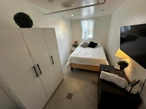 a small bedroom with a bed and a window at Culver City Hostel in Los Angeles