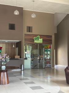 a fast food restaurant with a table in a room at Flat B306 Village Aldeia das Águas in Barra do Piraí +79 photos