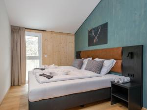 a bedroom with a large bed in a room at Aquarius Haus 8 TOP 17 in Sankt Lorenzen ob Murau
