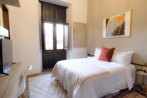 מיטה או מיטות בחדר ב-Casa Ibarra