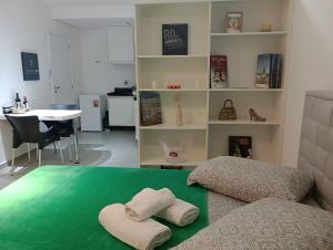 a room with a bed with two towels on it at Studio 811 in Marília