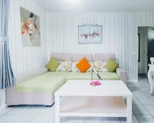 a living room with a couch and a table at Lagoon Dream in Moorea