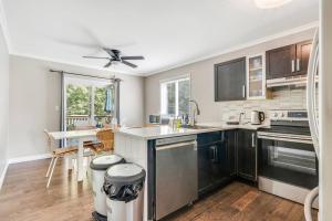 a kitchen with stainless steel appliances and a table at Fun & Cozy Retreat: Nature & Games in Trenton