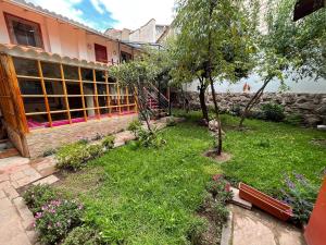 a garden in front of a building at Anka Wasi Lodging in Cusco