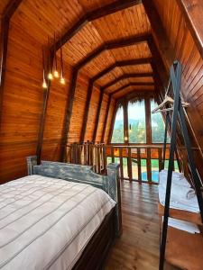 a bedroom with a bed in a wooden room at Doa Bungalov & Tiny House in Sapanca