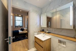 a bathroom with a sink and a mirror at Luxury 2BR Apt In City Centre in Manchester