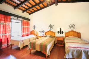 Postel nebo postele na pokoji v ubytování Hotel Pie de la Sierra