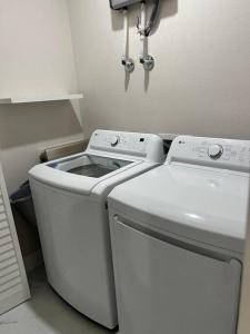 a white washer and dryer in a small room at Charming Luxury House in Largo