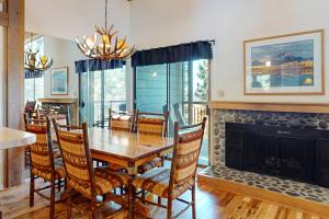 a dining room with a table and a fireplace at View Condo at Northstar in Truckee