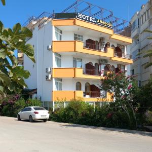 a hotel with a car parked in front of it at Hotel Anadolu in Finike