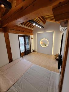 Un dormitorio con una cama grande en una habitación con techos de madera. en Gyeongju Hwarangroo en Gyeongju