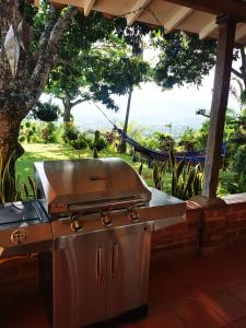 a barbecue grill sitting on top of a patio at Finca con forma de castillo y piscina en Sopetrán in Sopetran