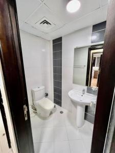 a bathroom with a toilet and a sink at Single Partition Room in Al Barsha 1 Near Mashreq Metro in Dubai