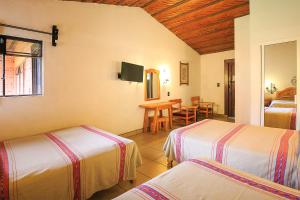 Postel nebo postele na pokoji v ubytování Hotel Pie de la Sierra