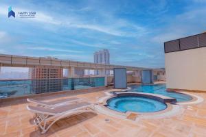 a pool on the roof of a building at Spacious 2BR near MOE - 2 Min Drive in Dubai