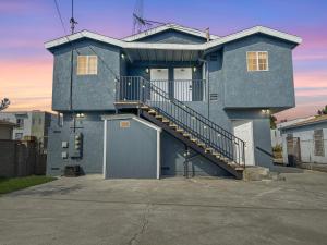 a blue house with a staircase in front of it at Discount For 30 Days Plus Stay In Culver City in Los Angeles